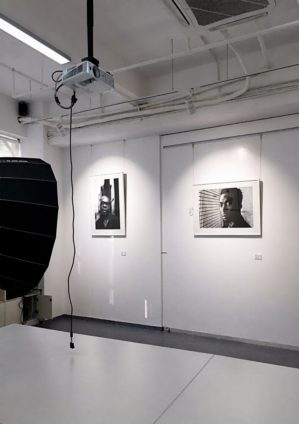 Photography gallery — framed prints under track spots