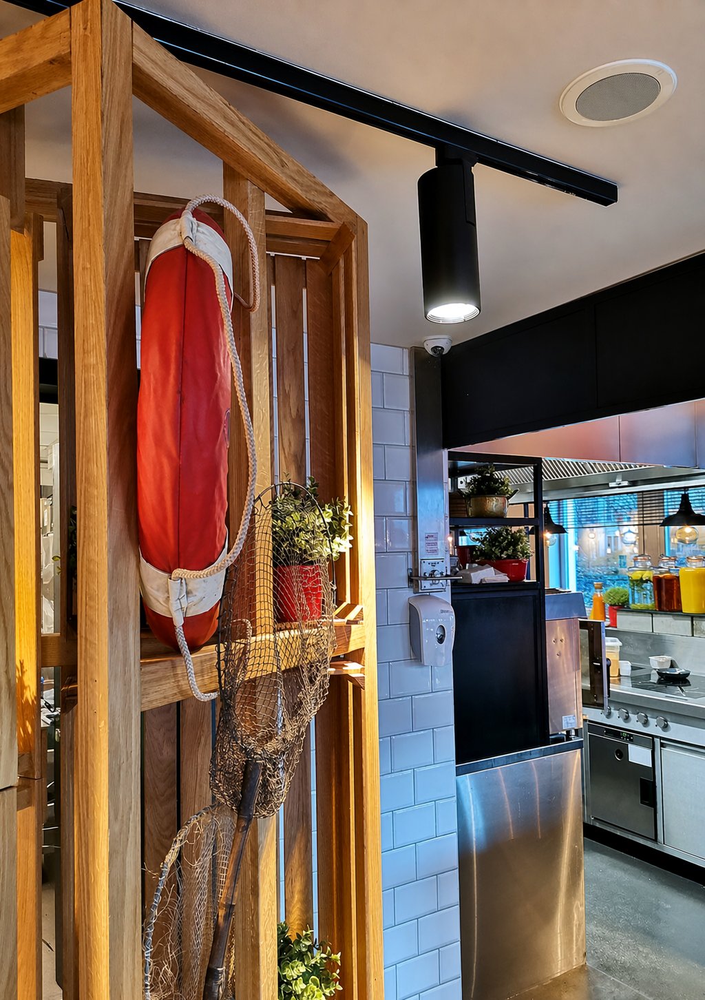 Café — black track spots over counter and shelving